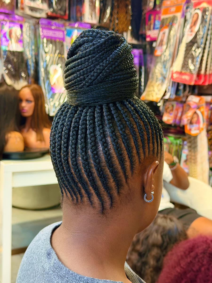 Knotless Updo Bun — Knotless & box braids by Qasr Alshar Salon, Dubai — gentle, protective styling for Afro-textured hair near Union Metro, Deira.